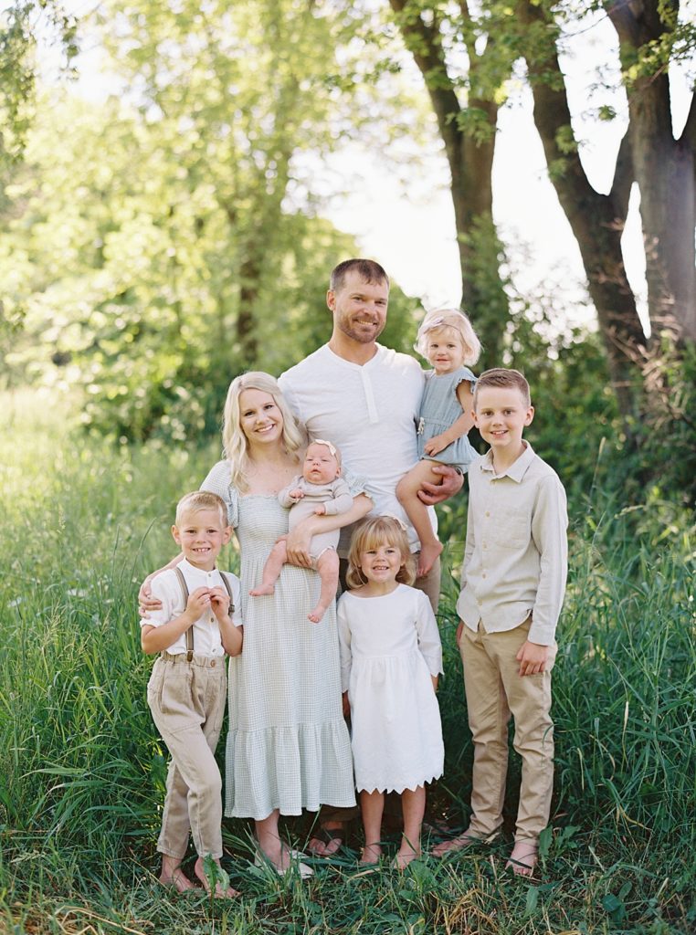 family of seven in a green field wearing neutral colors 2021 year in review